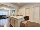 Modern kitchen features an island with bar stools and an open design with a view of the living area at 1005 Belfry Ter, Fairburn, GA 30213
