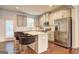 Modern kitchen with white cabinets, granite countertops, stainless steel appliances, and island seating at 1005 Belfry Ter, Fairburn, GA 30213