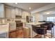 Contemporary kitchen with stainless steel appliances, granite countertops, island seating, and modern lighting at 1005 Belfry Ter, Fairburn, GA 30213
