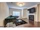 Stunning living room featuring hardwood floors, modern fireplace, stylish furniture, and contemporary lighting fixture at 1005 Belfry Ter, Fairburn, GA 30213