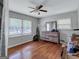Bright, spacious bedroom with hardwood floors, a ceiling fan, and abundant natural light filtering through large windows at 3059 Will Rogers Se Pl, Atlanta, GA 30316