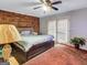 Charming bedroom with accent brick wall, plush carpet and a king bed at 3059 Will Rogers Se Pl, Atlanta, GA 30316