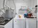 Functional laundry room features a washer and dryer with storage shelves at 3059 Will Rogers Se Pl, Atlanta, GA 30316
