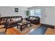 Inviting living room featuring hardwood floors, comfortable seating, and soft natural light from nearby windows at 3059 Will Rogers Se Pl, Atlanta, GA 30316