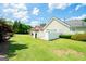 Spacious backyard featuring a well-manicured lawn, mature trees and a white fence at 335 Grand Teton Cir, Fayetteville, GA 30215