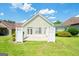 Wide open green backyard featuring a patio, well-kept grass, bushes and a white fence at 335 Grand Teton Cir, Fayetteville, GA 30215