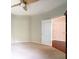 Spacious bedroom featuring neutral carpet, ceiling fan, and access to another room at 335 Grand Teton Cir, Fayetteville, GA 30215
