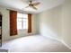 Comfortable bedroom featuring neutral carpet, large window, and ceiling fan at 335 Grand Teton Cir, Fayetteville, GA 30215