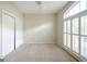 Bright bedroom featuring shuttered windows, ceiling fan, and closet space at 335 Grand Teton Cir, Fayetteville, GA 30215
