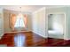 Elegant dining room featuring a chandelier, hardwood floors, and large windows at 335 Grand Teton Cir, Fayetteville, GA 30215