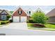 Charming brick home with a two-car garage and well-manicured lawn and landscaping at 335 Grand Teton Cir, Fayetteville, GA 30215