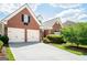 Attractive brick home featuring an attached two-car garage and well-kept landscaping at 335 Grand Teton Cir, Fayetteville, GA 30215