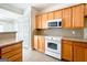 A bright kitchen features tiled floors and stainless steel appliances at 335 Grand Teton Cir, Fayetteville, GA 30215