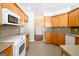 Kitchen with tile floors, stainless appliances, and wood cabinets at 335 Grand Teton Cir, Fayetteville, GA 30215
