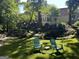 Sprawling backyard featuring a deck, fire pit, and lush landscaping at 3146 Weymouth Dr, Marietta, GA 30062