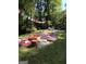 Backyard picnic setup with blankets, pillows, tables, and hanging lanterns in wooded area at 3146 Weymouth Dr, Marietta, GA 30062