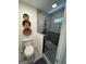 Modern bathroom with glass shower, hexagon floors, and decorative wall baskets at 3146 Weymouth Dr, Marietta, GA 30062
