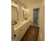 Modern bathroom features double sinks, stylish wallpaper, and an adjacent shower at 3146 Weymouth Dr, Marietta, GA 30062