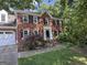 Charming two-story brick home with black shutters and attached garage in wooded setting at 3146 Weymouth Dr, Marietta, GA 30062