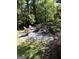 Cozy backyard fire pit with Adirondack chairs nestled in a landscaped setting at 3146 Weymouth Dr, Marietta, GA 30062