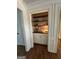 Hallway nook has custom shelving and cabinets for storage and display of decor at 3146 Weymouth Dr, Marietta, GA 30062