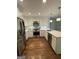 Updated kitchen has stainless steel appliances, bright white cabinets, and hardwood floors at 3146 Weymouth Dr, Marietta, GA 30062