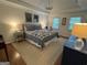 Bright main bedroom with a comfortable queen size bed, artwork and plenty of natural light at 3146 Weymouth Dr, Marietta, GA 30062