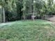 Backyard with overgrown grass and trees at 4116 Warrior Trl, Stone Mountain, GA 30083