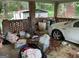 Carport filled with trash and debris in need of thorough cleaning at 4116 Warrior Trl, Stone Mountain, GA 30083