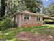 Single story brick home with a yard and mature shade trees at 4116 Warrior Trl, Stone Mountain, GA 30083