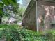 Back exterior shot shows the brick construction and mature trees at 4116 Warrior Trl, Stone Mountain, GA 30083