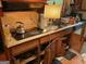 Outdated kitchen featuring wood cabinets, laminate countertop, and standard appliances at 4116 Warrior Trl, Stone Mountain, GA 30083