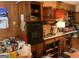 Outdated kitchen featuring wood cabinets, laminate countertop, and standard appliances at 4116 Warrior Trl, Stone Mountain, GA 30083