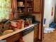 Dated kitchen featuring wood cabinets, laminate countertops, and standard dishwasher at 4116 Warrior Trl, Stone Mountain, GA 30083