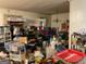 Overfilled living room featuring shelves and various items scattered around the space at 4116 Warrior Trl, Stone Mountain, GA 30083