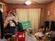 A cluttered living room with wood paneling and curtained windows at 4116 Warrior Trl, Stone Mountain, GA 30083