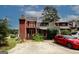 Two-story townhouse boasts a balcony, patio, and off-street parking on a sunny day at 5461 Park S Pl, Atlanta, GA 30349