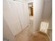 Hallway with stairs and folding closet doors leading into a bedroom at 5461 Park S Pl, Atlanta, GA 30349