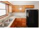 Functional kitchen features stainless steel sink, granite countertops, and wooden cabinets at 5461 Park S Pl, Atlanta, GA 30349