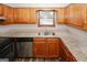 Updated kitchen featuring stylish counters, wood cabinets, and stainless steel appliances at 5461 Park S Pl, Atlanta, GA 30349