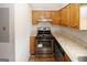 Updated kitchen featuring granite counters, wood cabinets, and stainless steel appliances at 5461 Park S Pl, Atlanta, GA 30349
