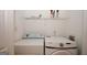 Bright laundry room with Samsung washer and dryer and wire shelving above at 5461 Park S Pl, Atlanta, GA 30349