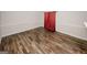 Large living room with wood flooring and a red curtain accent wall at 5461 Park S Pl, Atlanta, GA 30349