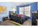 Blue bedroom featuring a double bed, dresser, and natural light at 138 Brookhaven Dr, Villa Rica, GA 30180