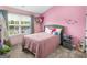 Charming bedroom with pink walls, a comfy bed, and lots of natural light at 138 Brookhaven Dr, Villa Rica, GA 30180