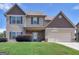 Charming two-story home with stone accents, two-car garage, and well-maintained lawn at 138 Brookhaven Dr, Villa Rica, GA 30180