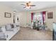 Inviting living room with plush gray sofa, carpet, and large window at 138 Brookhaven Dr, Villa Rica, GA 30180