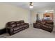 Comfortable living room with leather furniture, ceiling fan, and connecting kitchen view at 138 Brookhaven Dr, Villa Rica, GA 30180