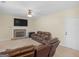 Spacious living room with a stone fireplace, ceiling fan, and comfortable leather seating at 138 Brookhaven Dr, Villa Rica, GA 30180