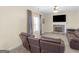 Bright living room with fireplace, a ceiling fan and lots of natural light from the large windows at 138 Brookhaven Dr, Villa Rica, GA 30180